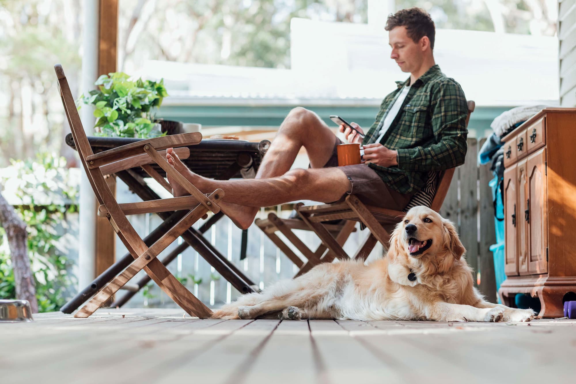 young man relaxing at home with dog